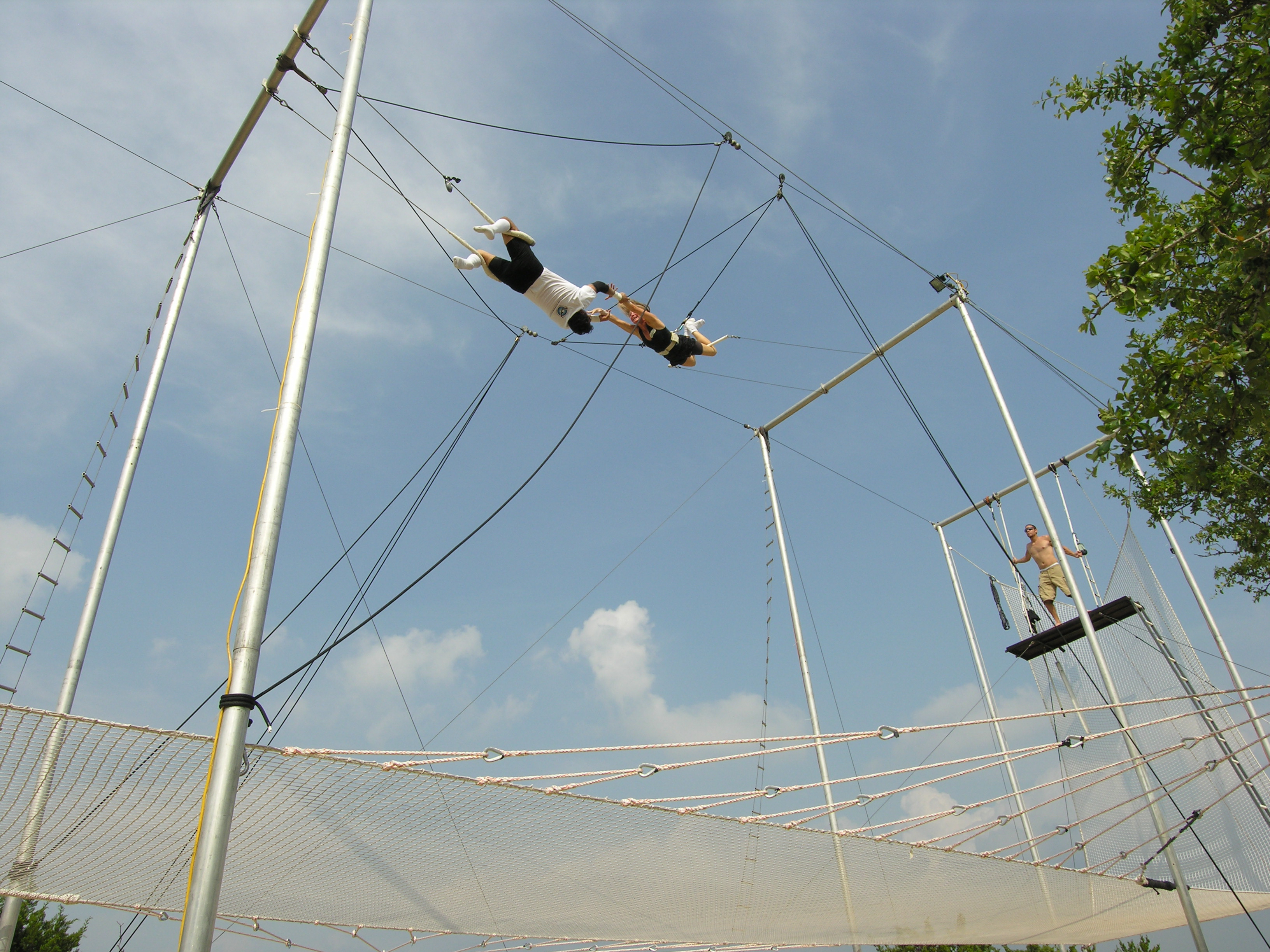nancy Addison, nutritionist, took trapeze lessons and she is in the photo getting caught by the trapeze artist.